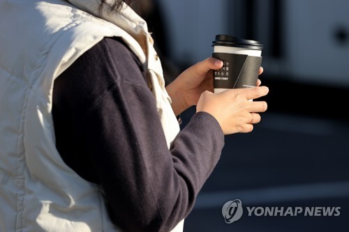 쌀쌀한 아침 날씨를 보인 2일 오전 서울 종로구 광화문네거리에서 시민이 따뜻한 음료를 들고 있다.  /연합뉴스