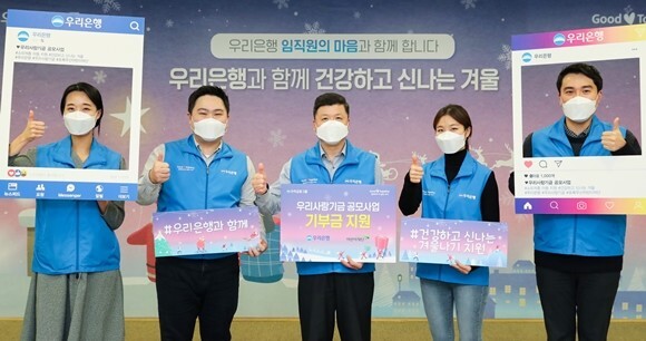 권광석 우리은행장(가운데)이 코로나19로 인한 돌봄 공백으로 어려움을 겪는 소외계층 아동을 위한 '우리(WOORI)와 함께 건강하고 신나는 겨울' 공모사업을 알리고 있다. /우리은행 제공
