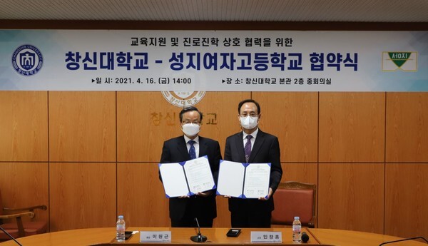 이원근 창신대학교 총장(왼쪽)과 민창홍 성지여고 교장(오른쪽)이 기념촬영을 하고 있다(사진=부영그룹 제공)